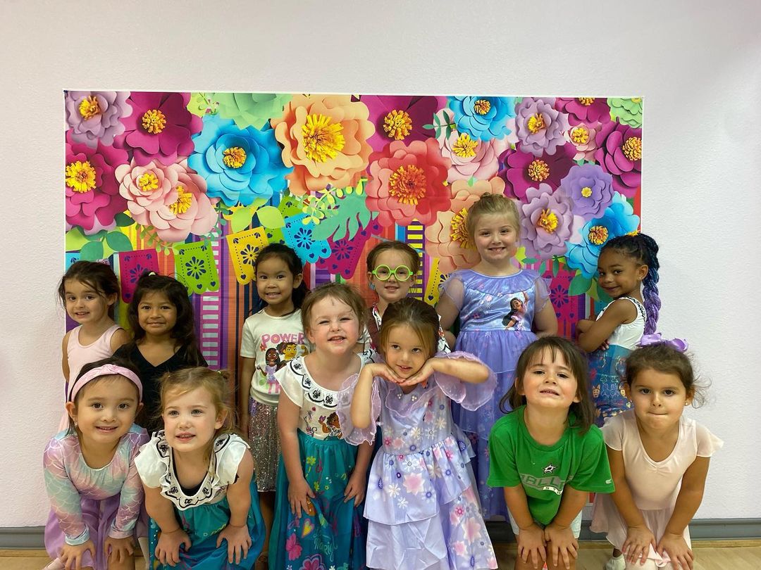 young group of summer dancers in encanto outfits